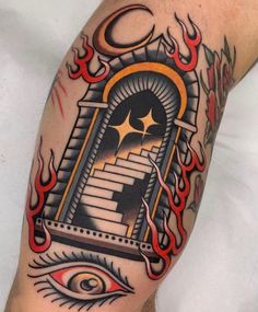 a man's arm with an eye and door tattoo on it