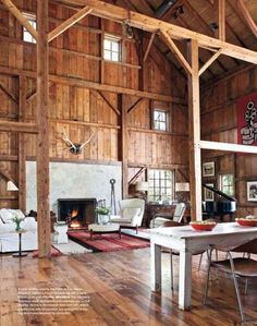 a living room filled with furniture and a fire place in the middle of a building