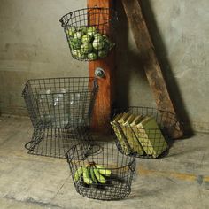 three wire baskets with apples and bananas in them