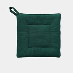 a small green pouch with a handle on the side and a square in the middle