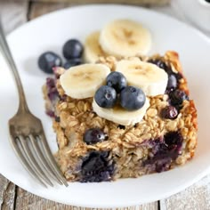 a white plate topped with granola and blueberries