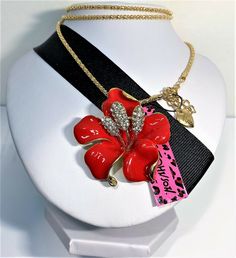 BETSEY JOHNSON NECKLACE , PENDANT, BROOCH & PIN  THIS FLOWER IS A GOLD BACK WITH RED ENAMEL PETALS  HAND SET CLEAR CRYSTALS IN BUDS 1 3/4" WIDE 2" IN LENGTH A BETSEY JOHNSON GOLD CHAIN 23" IN LENGTH 2" EXT. A BETSEY JOHNSON GOLD HEART TAG Arrives in pretty gift box ( while supplies last ) or lovely organza bag. IMPORTANT INFORMATION -  PLEASE READ THE FULL DESCRIPTION FOR THE SIZE OF THE ITEM(S) BEING PURCHASED ~ AS THE PICTURES MAY MAKE THE ITEM(S) APPEAR LARGER THAN DESCRIBED ~ ALSO, PLEASE KEEP IN MIND THAT LIGHTING & DIFFERENT MONITORS MAY AFFECT COLOR(S).  ANY QUESTIONS PLEASE CONTACT ME! PLEASE VISIT MY STORE ~ JEWEL ALLEY ~ FOR MORE GREAT BETSEY JOHNSON JEWELRY ~  One of a kind - RAWSON ORIGINALS ~ STERLING & TIBETAN SILVER . Thank you for visiting ~ Please visit again. Betsey Johnson Necklace, Pendant Brooch, Heart Tag, Pin Pendant, Betsey Johnson Jewelry, Clear Crystals, Pretty Gift, Gold Heart, Organza Bags