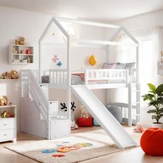 a child's bedroom with a white bunk bed and slide