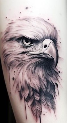 an eagle tattoo on the thigh with feathers and arrows around it's head, which is