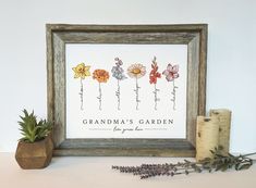 an old wooden frame with flowers on it next to some candles and a potted plant