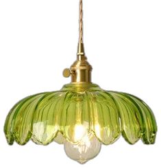 a green glass light hanging from a ceiling