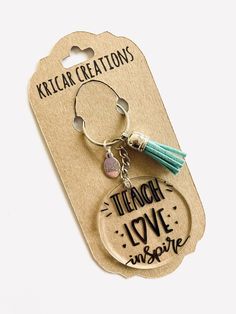 a keychain with a tassel on it that says teach love inspire