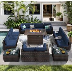 an outdoor living room with blue couches and fire pit