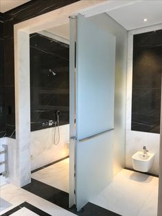 a bathroom with black and white marble walls