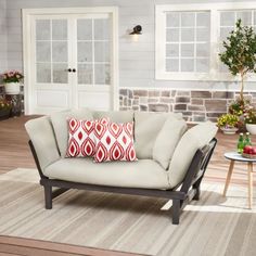 a living room filled with furniture and flowers on the side of the wall in front of it