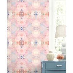 a room with a pink wallpaper and a blue dresser in front of the window