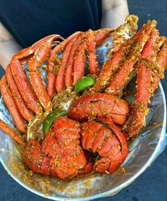 a plate full of cooked lobsters with spices on them and garnishes