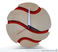 a clock made out of wood with red strips on the face and white hands is shown