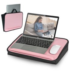 a laptop computer with a pink cover on it's side and a mouse in front of it