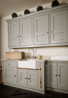 a kitchen with gray cabinets and a white sink