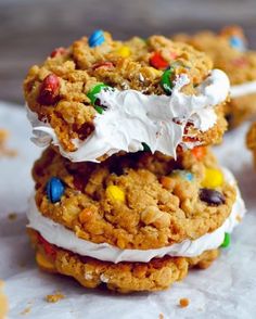 three cookies with white frosting and colorful candies