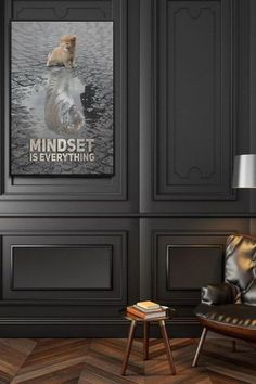 a living room with black walls and wooden flooring, a leather chair and a poster on the wall that says mindset everything