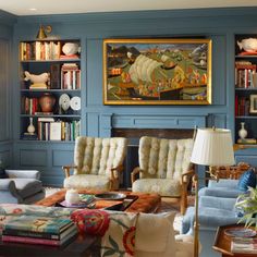 a living room filled with furniture and bookshelves