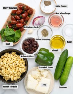 the ingredients for pasta salad laid out on a table