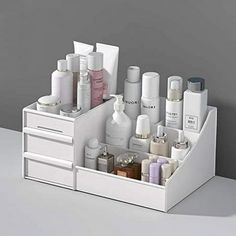 Product Description Overview: STONCEL makeup organizer is a perfect storage box for you bedroom and bathroom in hold brushes, creams, serums, tools, toners, lotions, hair spray, cotton ball and sperfume. As long as you see it, you will like it. I believe it is the cosmetic storage box you need. Advantages: Space Saver The makeup box is divided into 9 areas. Its a perfect skin care organizer for hold brushes, creams, serums, tools, toners, lotions, hair spray, cotton ball and sperfume. Also, it c Grey Makeup Organizer, Makeup Organiser Dresser, White Skincare Organizer, Bathroom Small Drawer Organization, Ideas For Bathroom Storage, Toner Storage, Skin Care Shelves, Makeup Storage Target, Makeup Desk Organization