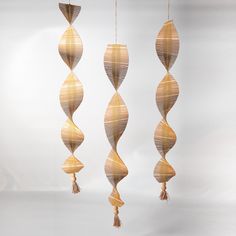 three decorative hanging objects made out of paper