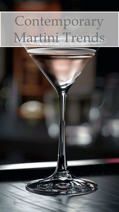 a close up of a martini glass on a table with the words contemporary martini trend