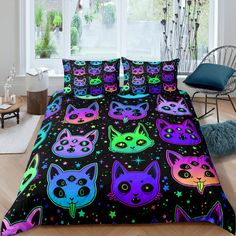 a bed with colorful cats and stars on it