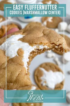 a hand holding a half eaten cookie with marshmallows on it and the words easy fluffernuter cookies marshmallow center