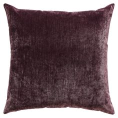 a purple velvet pillow on a white background