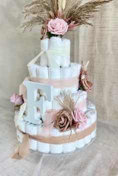 a three tiered diaper cake decorated with flowers