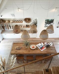 a wooden table with baskets hanging from the ceiling