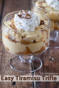 two desserts in small glass dishes on a wooden table with whipped cream and other toppings