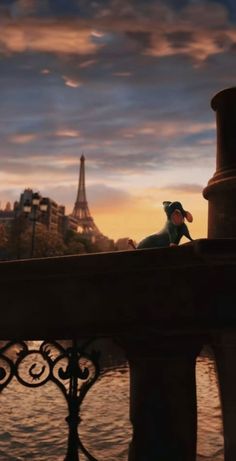 an animated figure sitting on top of a bridge next to the eiffel tower