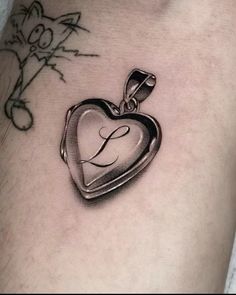 a tattoo with a heart shaped locke on it