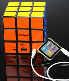 an ipod is plugged into a rubik cube