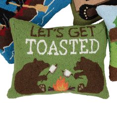 three pillows that say, let's get toasted and two bears are sitting next to each other