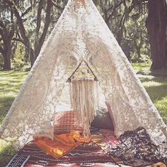 a teepee is set up in the grass