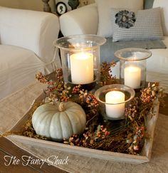 a tray with candles and some pumpkins on it