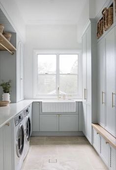 a washer and dryer in a white laundry room