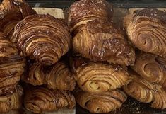 there are many croissants that are on the table together, and one is covered in chocolate