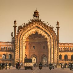 an ornate building with people walking around it