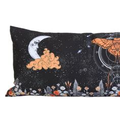 a black pillow with an orange butterfly on it and the moon in the sky above