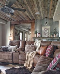 a living room filled with lots of furniture and pillows on top of it's couches