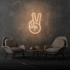 two chairs and a table in front of a wall with a peace sign on it