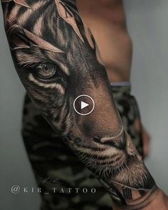 a man's arm with a tiger tattoo on it and an arrow in the middle