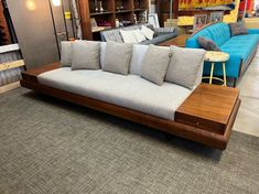 a couch and some chairs in a room with carpeted flooring at a furniture store