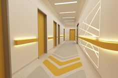 an empty hallway with yellow and white accents on the walls is lit by recessed lights