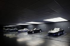 a group of cars parked in a parking garage next to each other on the floor