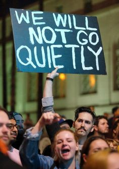 a person holding up a sign that says we will not go quietly