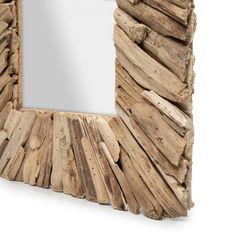 a mirror made out of driftwood on a white background